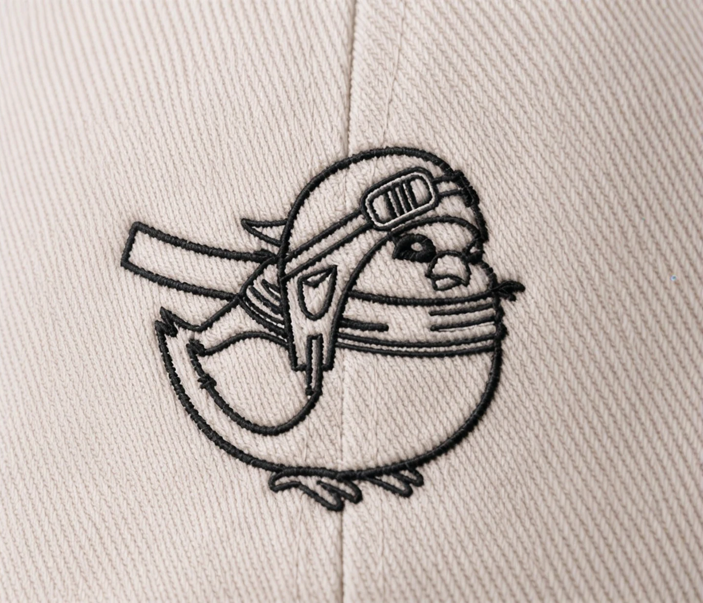 Close detail of the CoPilot AI birdie embroidery